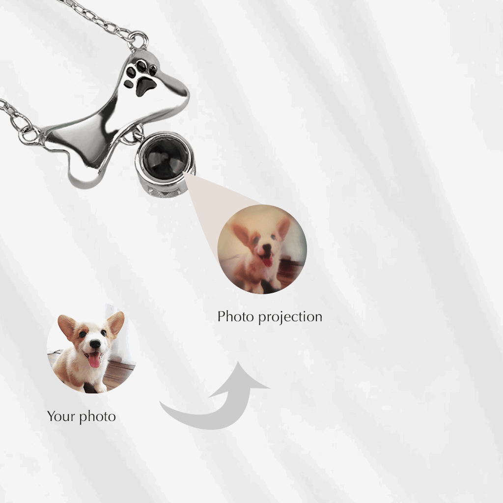 A photo projection necklace can project your customized picture onto a nearby surface. This dog bone charm with paw print, is a great pet memorial gift.