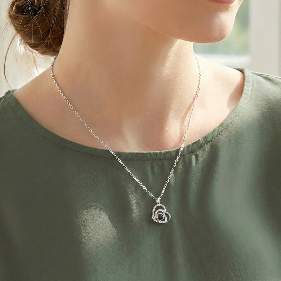 woman wearing a heart photo necklace