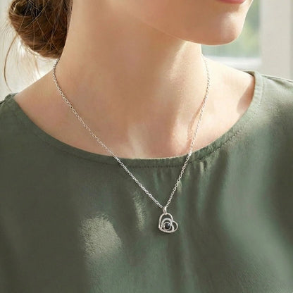 woman wearing a heart photo necklace
