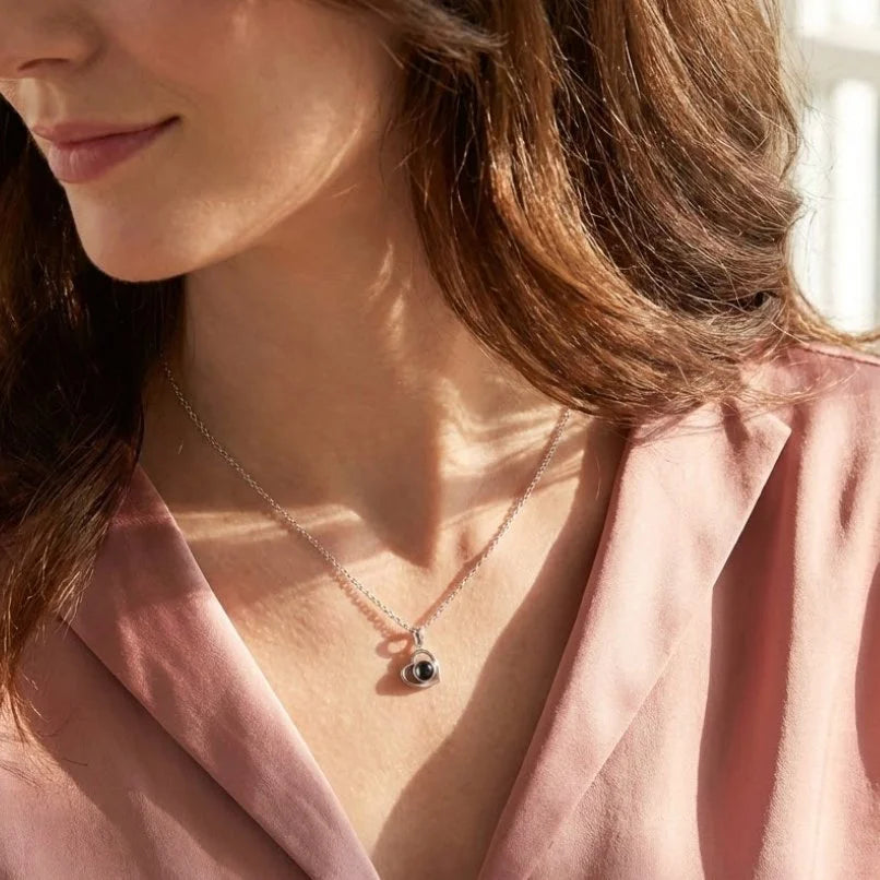 woman wearing a heart projection necklace