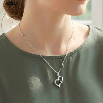 woman wearing a heart photo projection necklace
