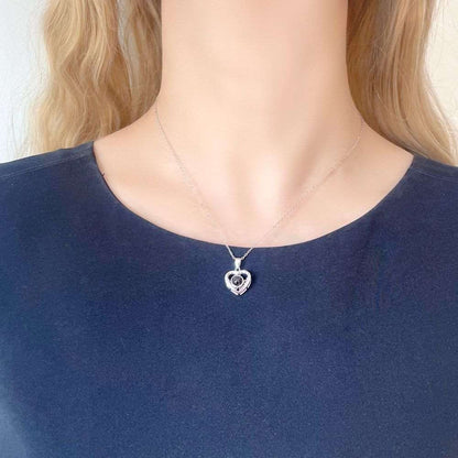 woman wearing heart necklace with picture inside