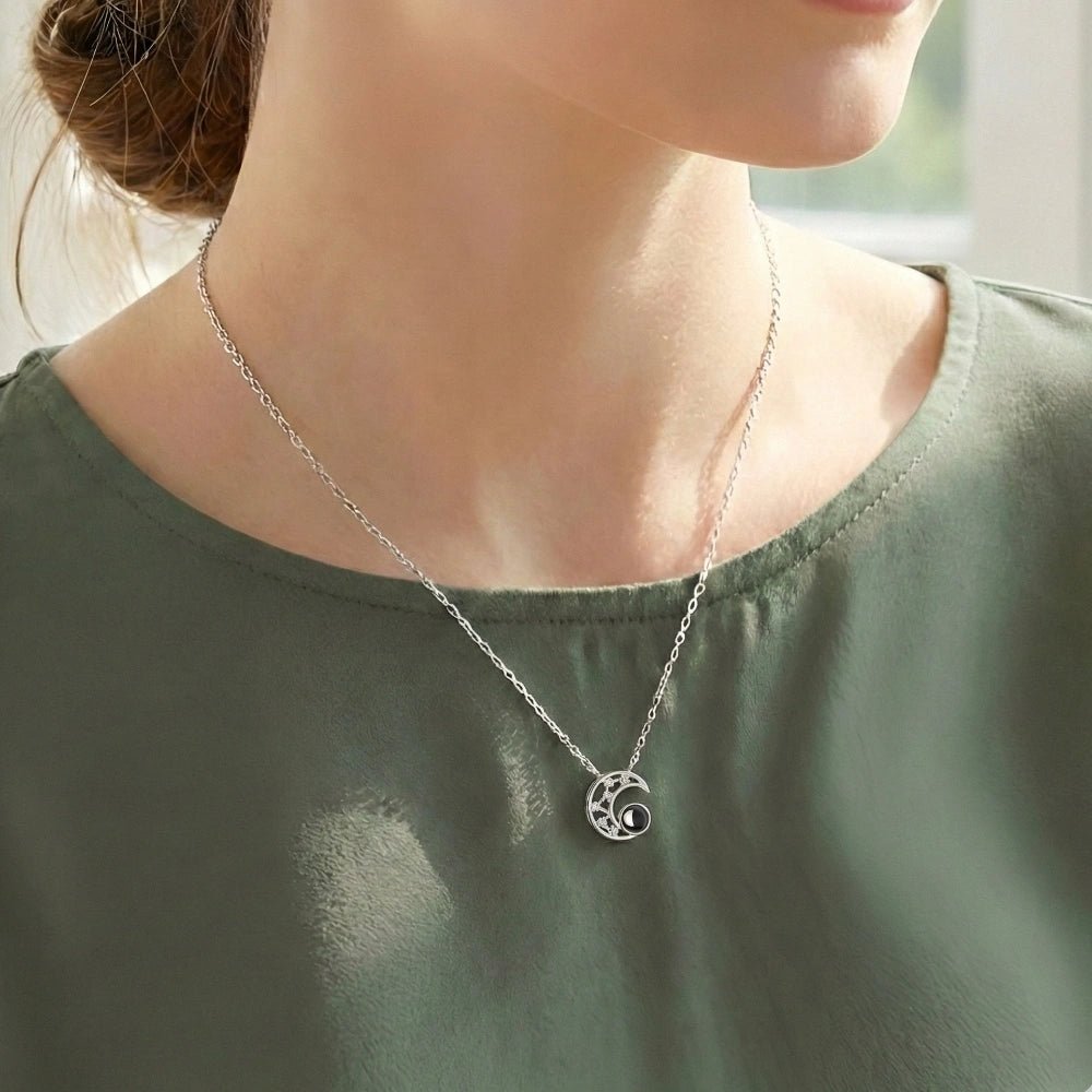woman wearing moon projection necklace