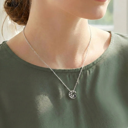 woman wearing moon projection necklace