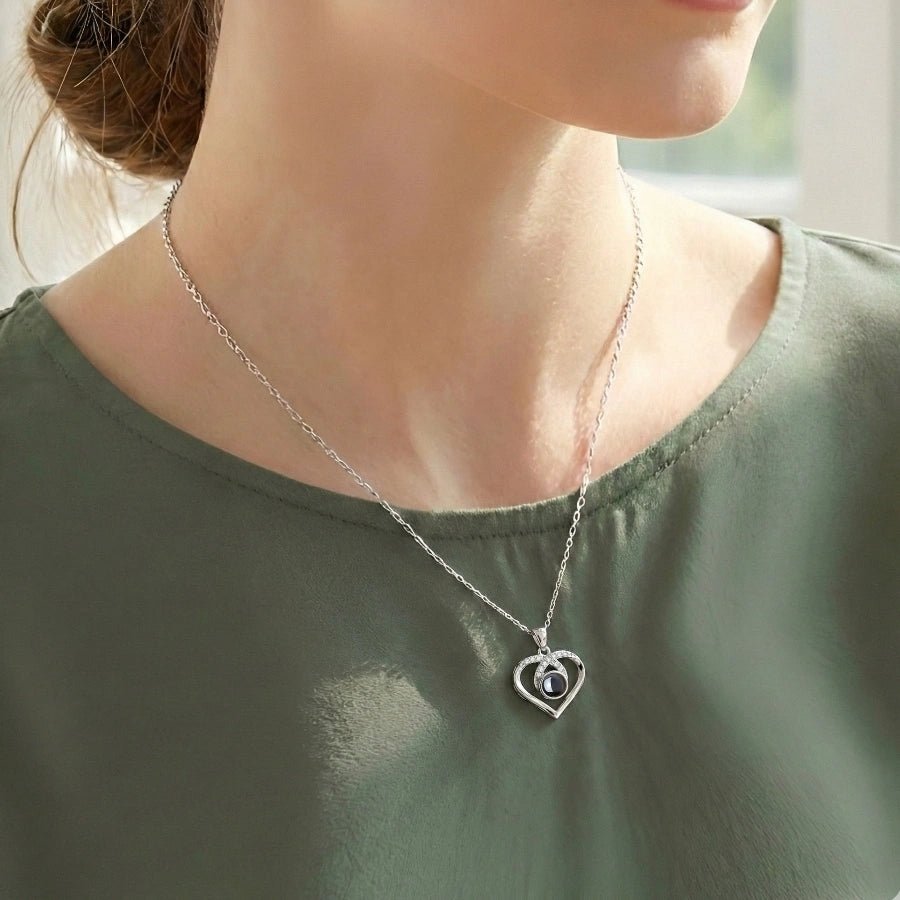 woman wearing a heart photo projection necklace that holds a custom picture inside