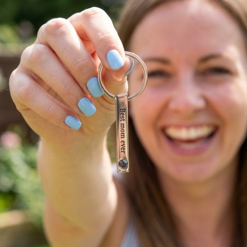 woman holding a Bar Projection Keychain with Custom Text 'Best mom ever' as Mother's Day gift