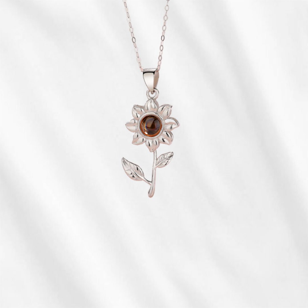 This sunflower necklace with picture inside is made with sterling silver.
