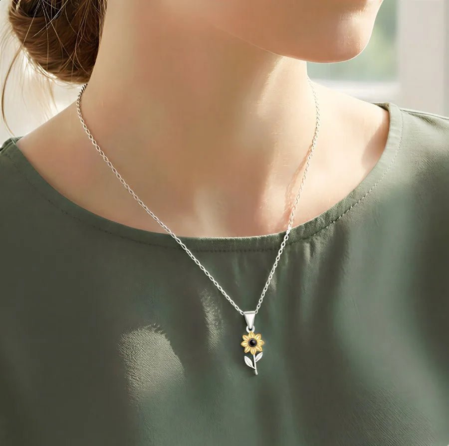 woman wearing a sunflower projection necklace with custom photo inside
