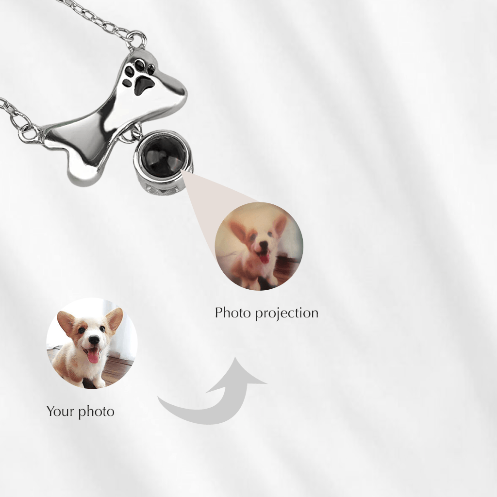 A photo projection necklace can project your customized picture onto a nearby surface. This dog bone charm with paw print, is a great pet memorial gift.