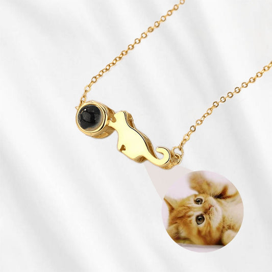Gold cat necklace with picture inside.