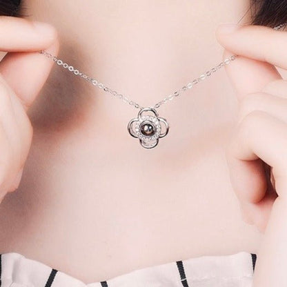 woman wearing clover necklace with picture inside stone