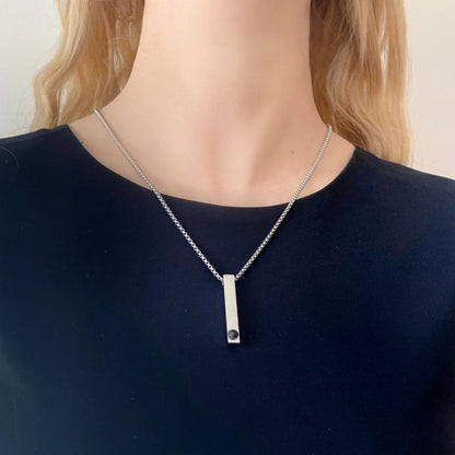 woman wearing a unisex bar projection photo necklace with pet photo inside