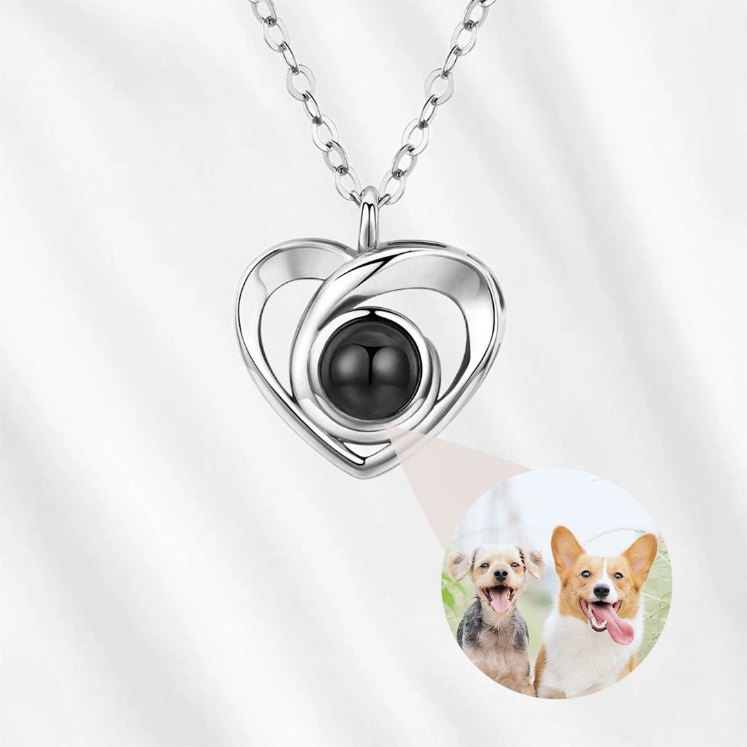 Heart projection necklace featuring two dogs